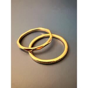 Two gold-plated rings SZ. 7 one polished facet band, one thin band w/ embedded